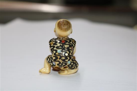 A Japanese ivory inlaid figurative netsuke